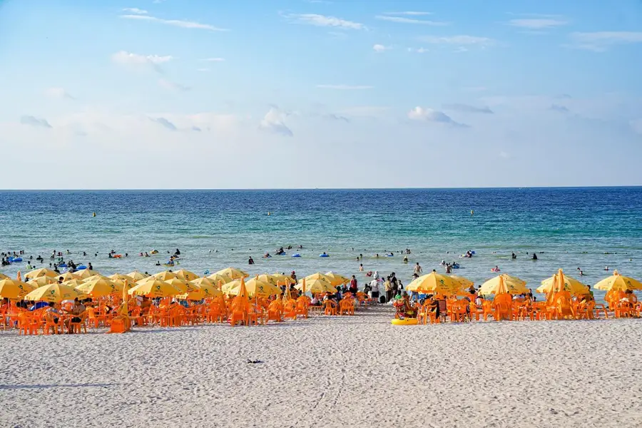White sand and orange parasols at Hamdeok Beach