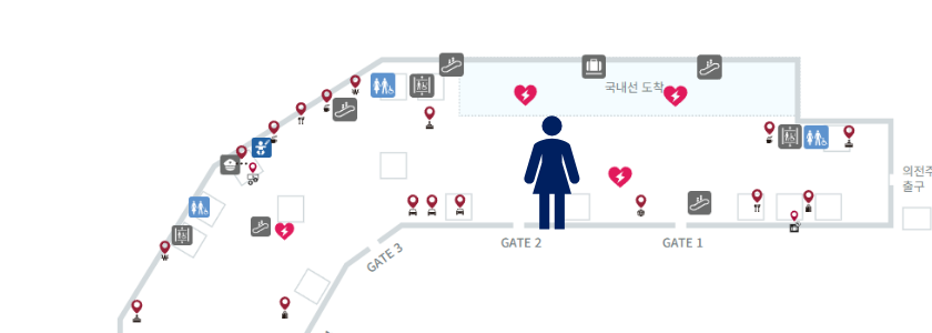 Level 1 arrivals floor plan from the PowerPoint with a person marking the shuttle guide's waiting point at Gate 2